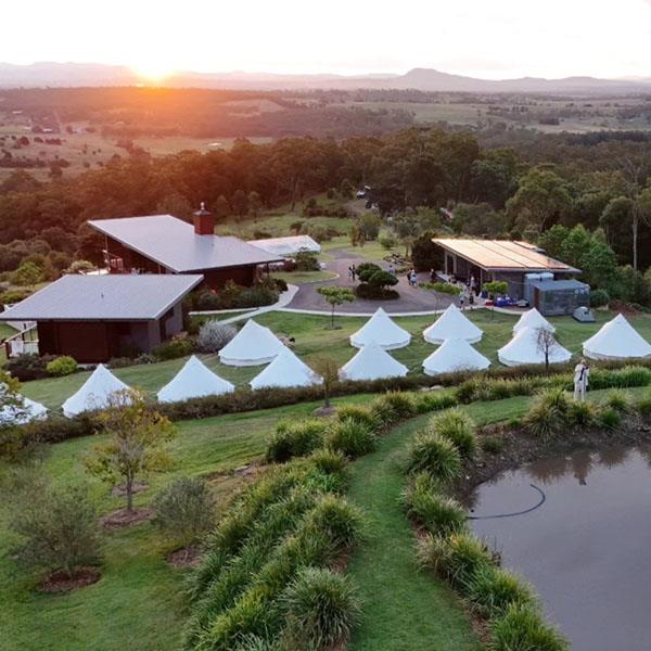 drone footage of a bell tent village