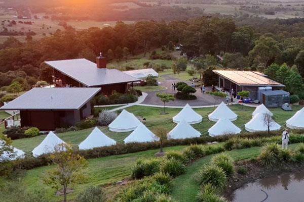 Corporate event bell tent village at sunset