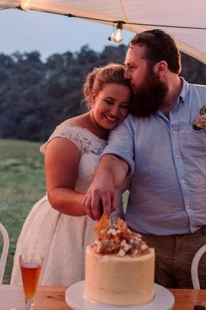 Smiling Bride and Groom under a large Starshade Marquee