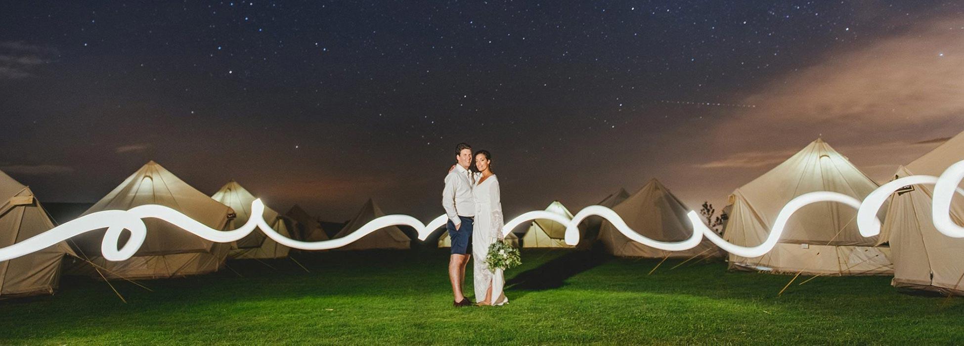 bell tent village illuminated under a starry sky