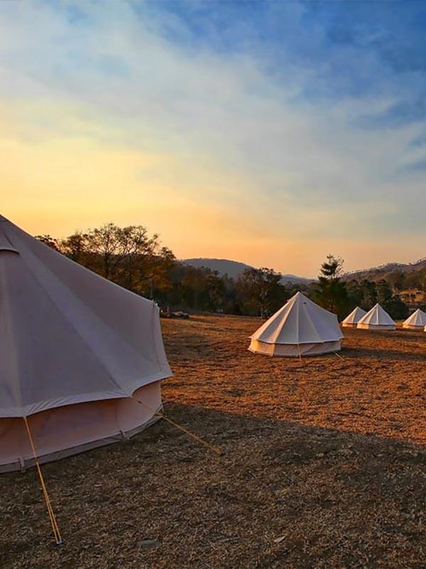 Multiple bell tents set up for corporate event accommodation