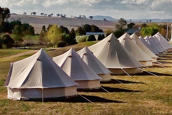 Bell tents setup in filed suitable for festival or retreat